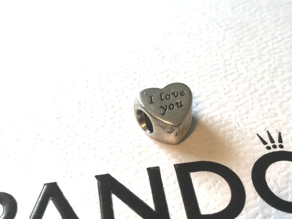 Elevate your bracelet with the Pandora Genuine 925 Sterling Silver I Love You Heart Charm, an emblem of affection and a timeless addition to your jewellery collection. The charm boasts an exquisite heart shape with the Wording… I Love you … engraved on both sides.