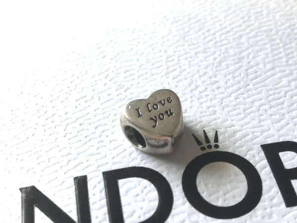 Elevate your bracelet with the Pandora Genuine 925 Sterling Silver I Love You Heart Charm, an emblem of affection and a timeless addition to your jewellery collection. The charm boasts an exquisite heart shape with the Wording… I Love you … engraved on both sides.